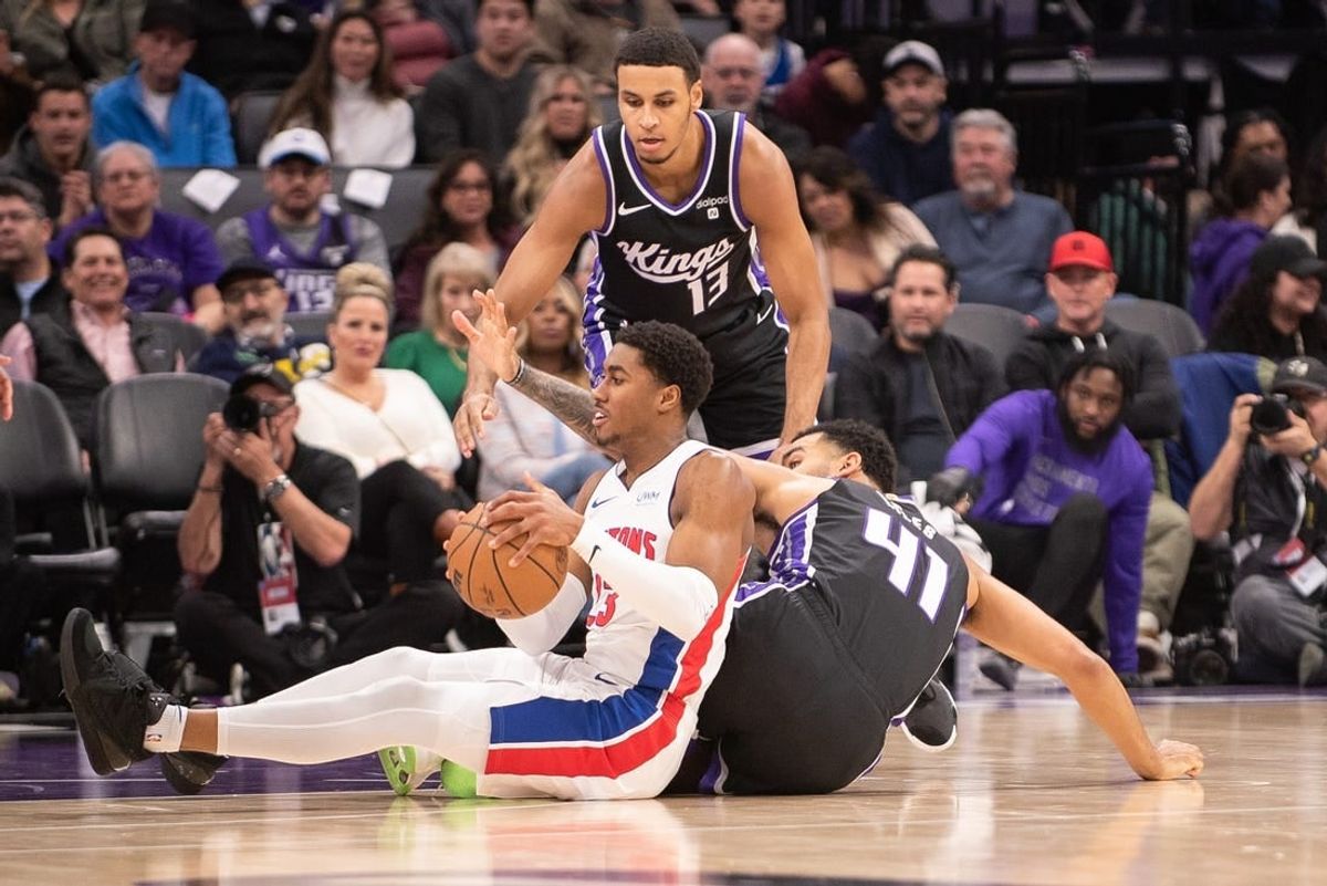 Feb 7, 2024; Sacramento, California, USA; Detroit Pistons guard Jaden Ivey (23) and Sacramento Kings forward Trey Lyles (41) fight for possession of the ball during the second quarter at Golden 1 Center.