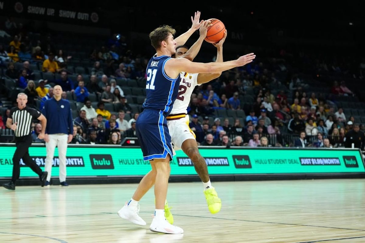 Nov 23, 2023; Las Vegas, Nevada, USA; Brigham Young Cougars guard Trevin Knell (21) defends against Arizona State Sun Devils guard Jose Perez (12) during the first half at Michelob Ultra Arena.