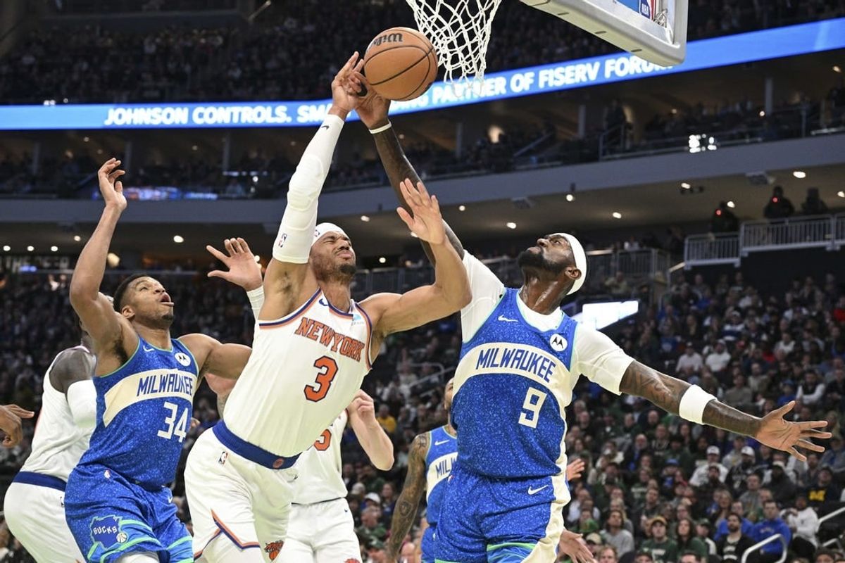 Dec 5, 2023; Milwaukee, Wisconsin, USA; New York Knicks guard Josh Hart (3) and Milwaukee Bucks forward Bobby Portis (9) battle for a rebound in the first half at Fiserv Forum.