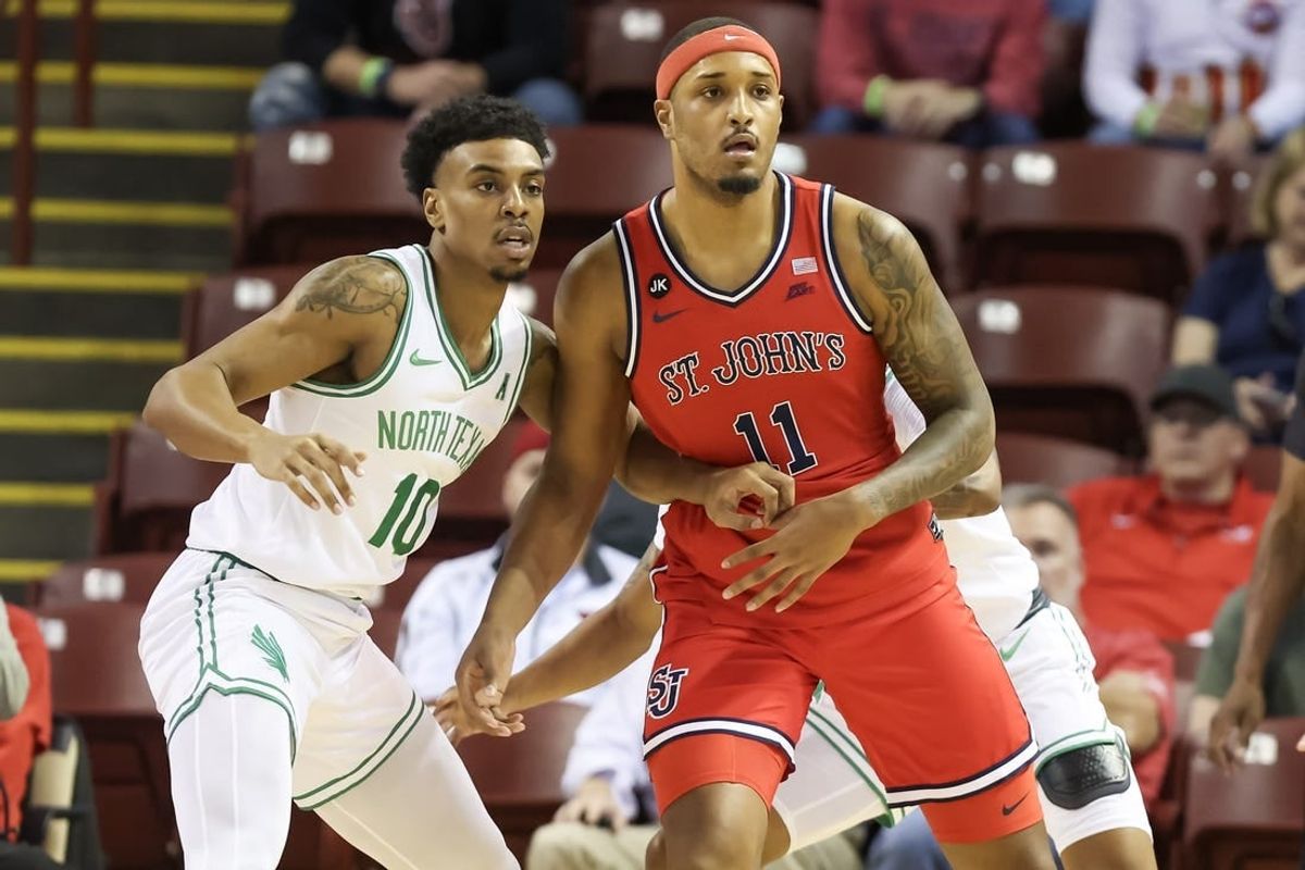 Nov 16, 2023; Charleston, South Carolina, USA; St. John's Red Storm center Joel Soriano (11) is defended by North Texas Mean Green forward Robert Allen (10) in the first half at TD Arena.