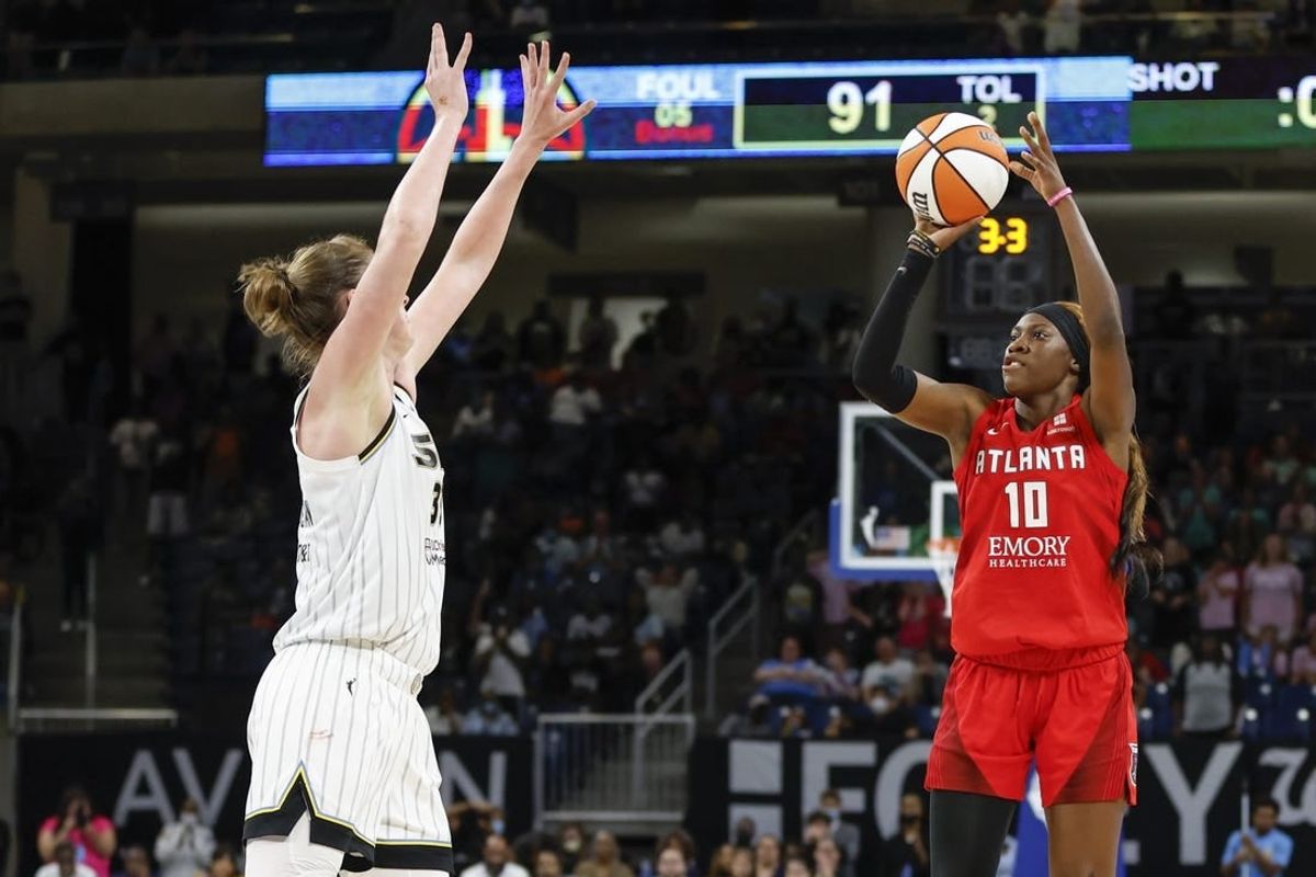 Jun 17, 2022; Chicago, Illinois, USA; Atlanta Dream guard Rhyne Howard (10) shoots against Chicago Sky forward Emma Meesseman (33) during the second half of a WNBA game at Wintrust Arena.