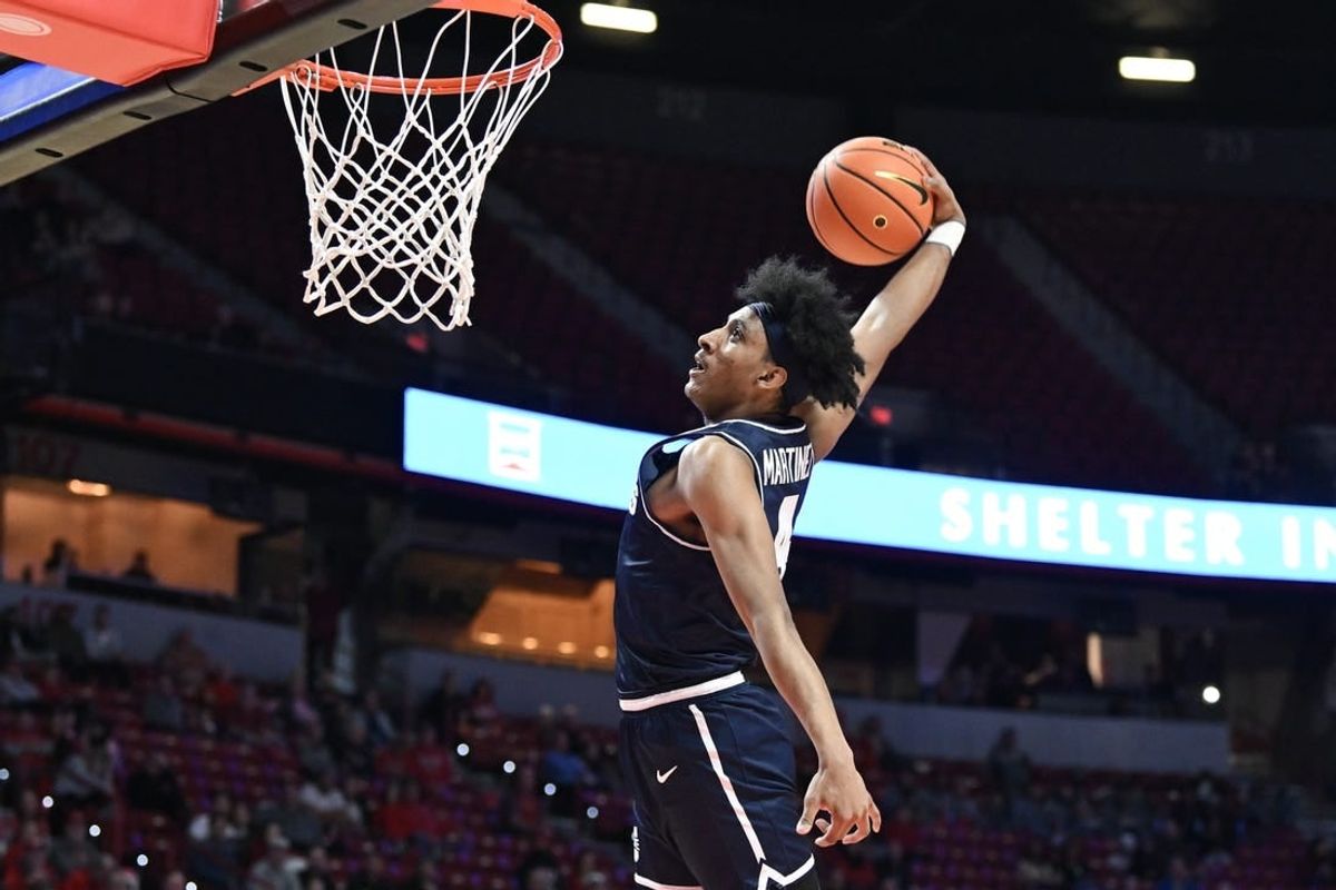 Jan 13, 2024; Las Vegas, Nevada, USA; Utah State Aggies guard Ian Martinez (4) dunks on the UNLV Rebels in the second half at Thomas & Mack Center.