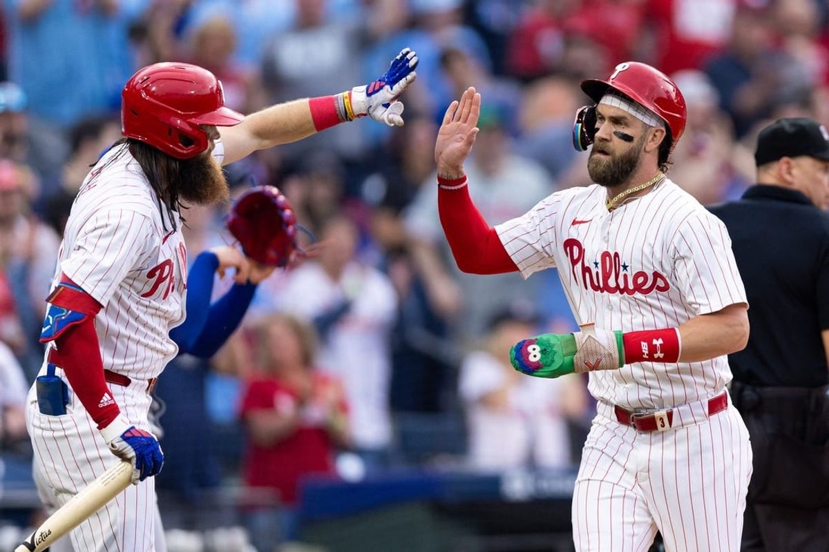 May 7, 2024; Philadelphia, Pennsylvania, USA;  Philadelphia Phillies first base Bryce Harper (3) high fives outfielder Brandon Marsh (16) after scoring during the first inning against the Toronto Blue Jays at Citizens Bank Park.