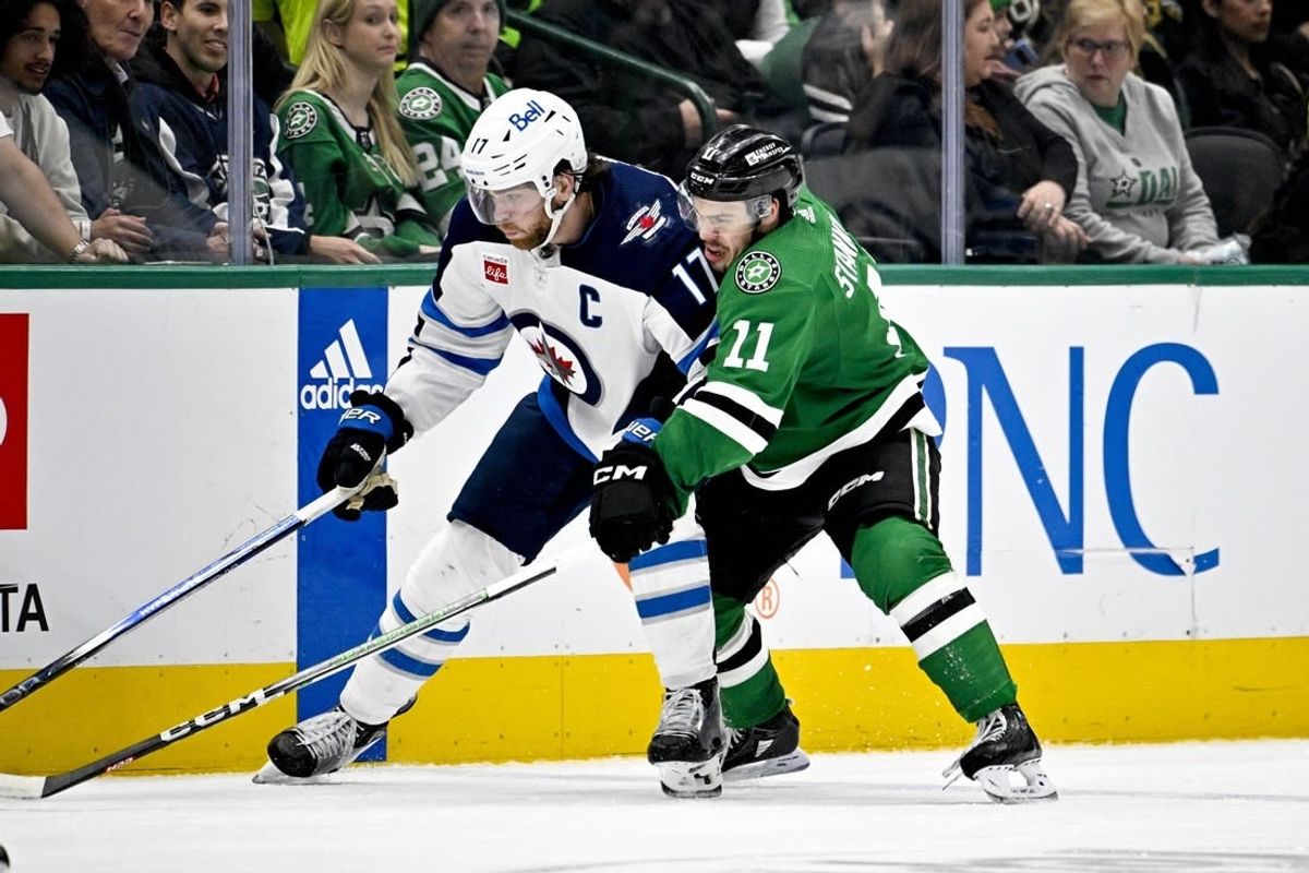 Feb 29, 2024; Dallas, Texas, USA; Winnipeg Jets center Adam Lowry (17) and Dallas Stars center Logan Stankoven (11) battle for control of the puck during the third period at the American Airlines Center.