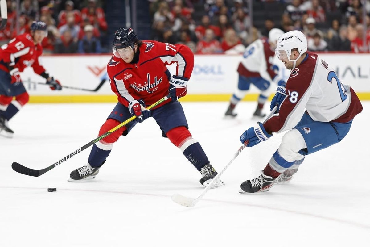Feb 13, 2024; Washington, District of Columbia, USA; Washington Capitals right wing T.J. Oshie (77) controls the puck as Colorado Avalanche left wing Miles Wood (28) defends in the second period at Capital One Arena.