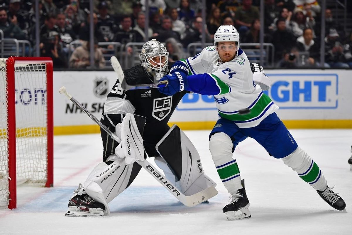 Mar 5, 2024; Los Angeles, California, USA; Vancouver Canucks center Pius Suter (24) moves in for the puck against Los Angeles Kings goaltender Cam Talbot (39) during the third period at Crypto.com Arena.