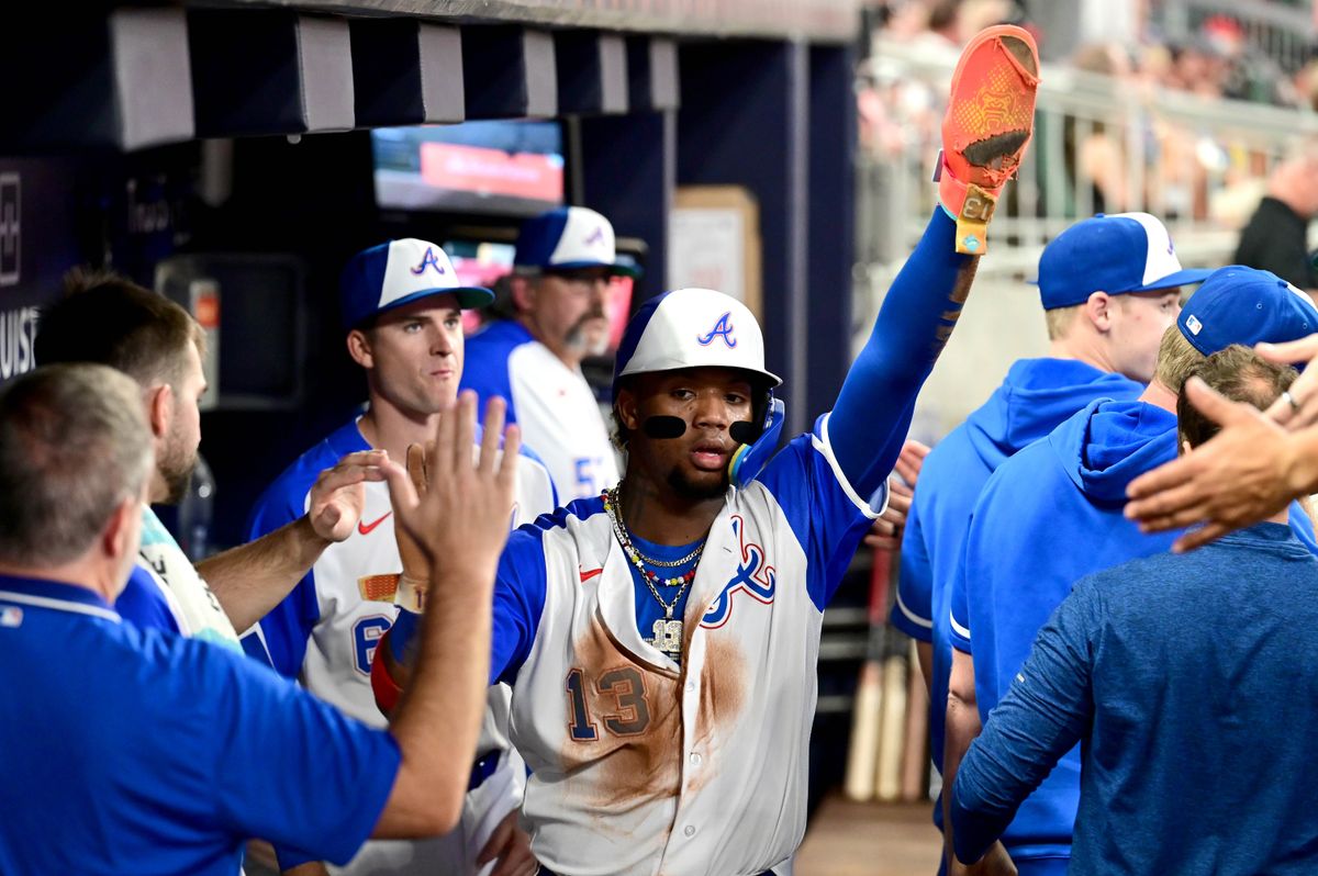ATLANTA, GEORGIA - SEPTEMBER 30: Ronald Acuna Jr. #13 of the Atlanta Braves celebrates in the dugout after scoring a run during the third inning against the Washington Nationals at Truist Park on September 30, 2023 in Atlanta, Georgia. (Photo by Adam Hagy/Getty Images)