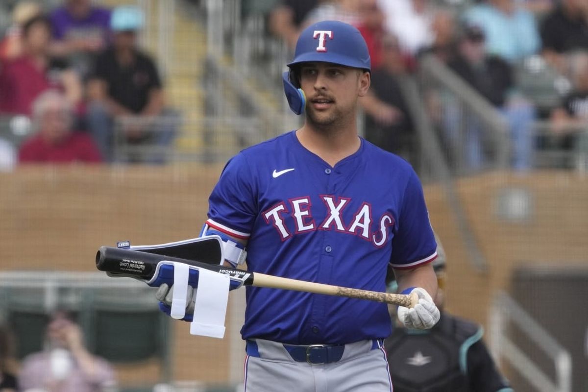 Feb 27, 2024; Salt River Pima-Maricopa, Arizona, USA; Texas Rangers first baseman Nathaniel Lowe (30) reacts after walking against the Arizona Diamondbacks during the first inning at Salt River Fields at Talking Stick.