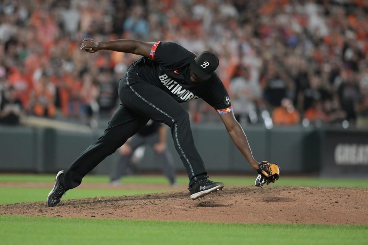 Aug 25, 2023; Baltimore, Maryland, USA; Baltimore Orioles relief pitcher Felix Bautista (74) slips while throwing a ninth inning pitch against the Colorado Rockies  at Oriole Park at Camden Yards.