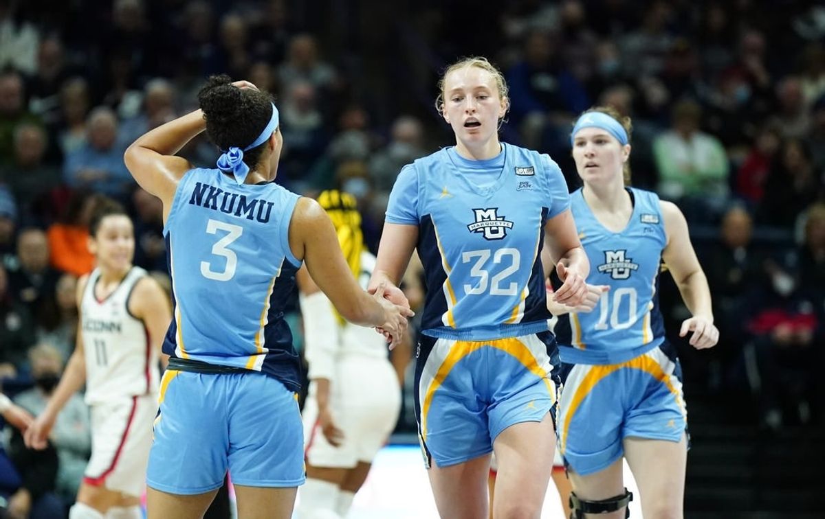 Dec 31, 2022; Storrs, Connecticut, USA; Marquette Golden Eagles forward Liza Karlen (32) and guard Rose Nkumu (3) react after a play against the UConn Huskies in the first half at Harry A. Gampel Pavilion.