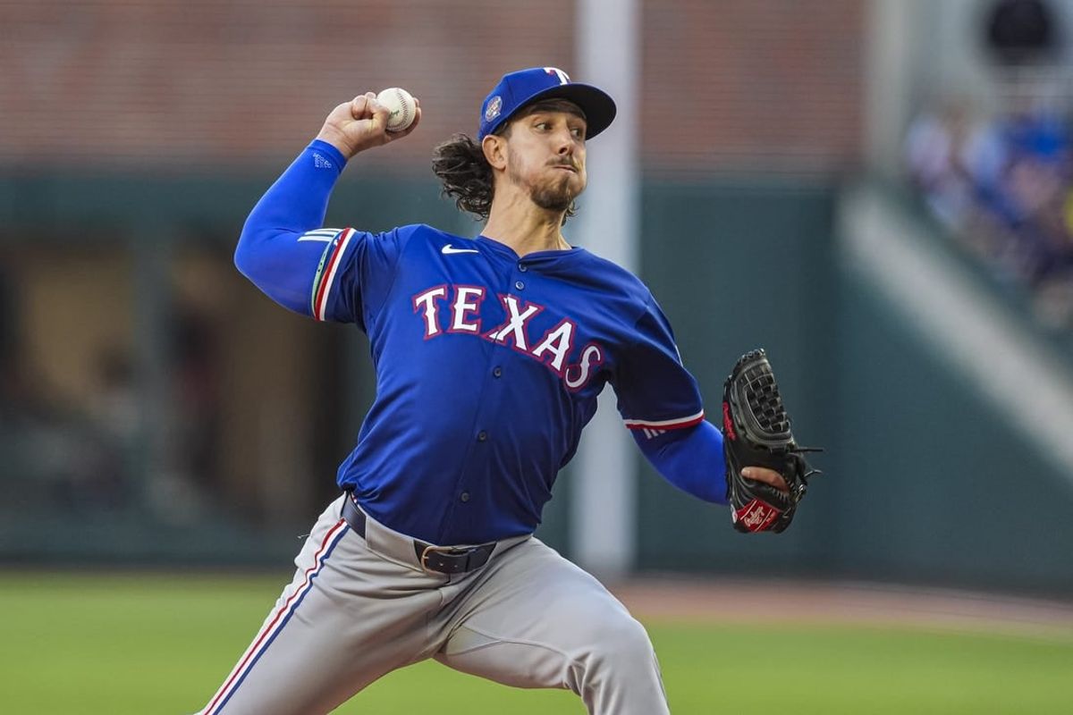 Apr 21, 2024; Cumberland, Georgia, USA; Texas Rangers starting pitcher Michael Lorenzen (23) pitches against the Atlanta Braves during the first inning at Truist Park.