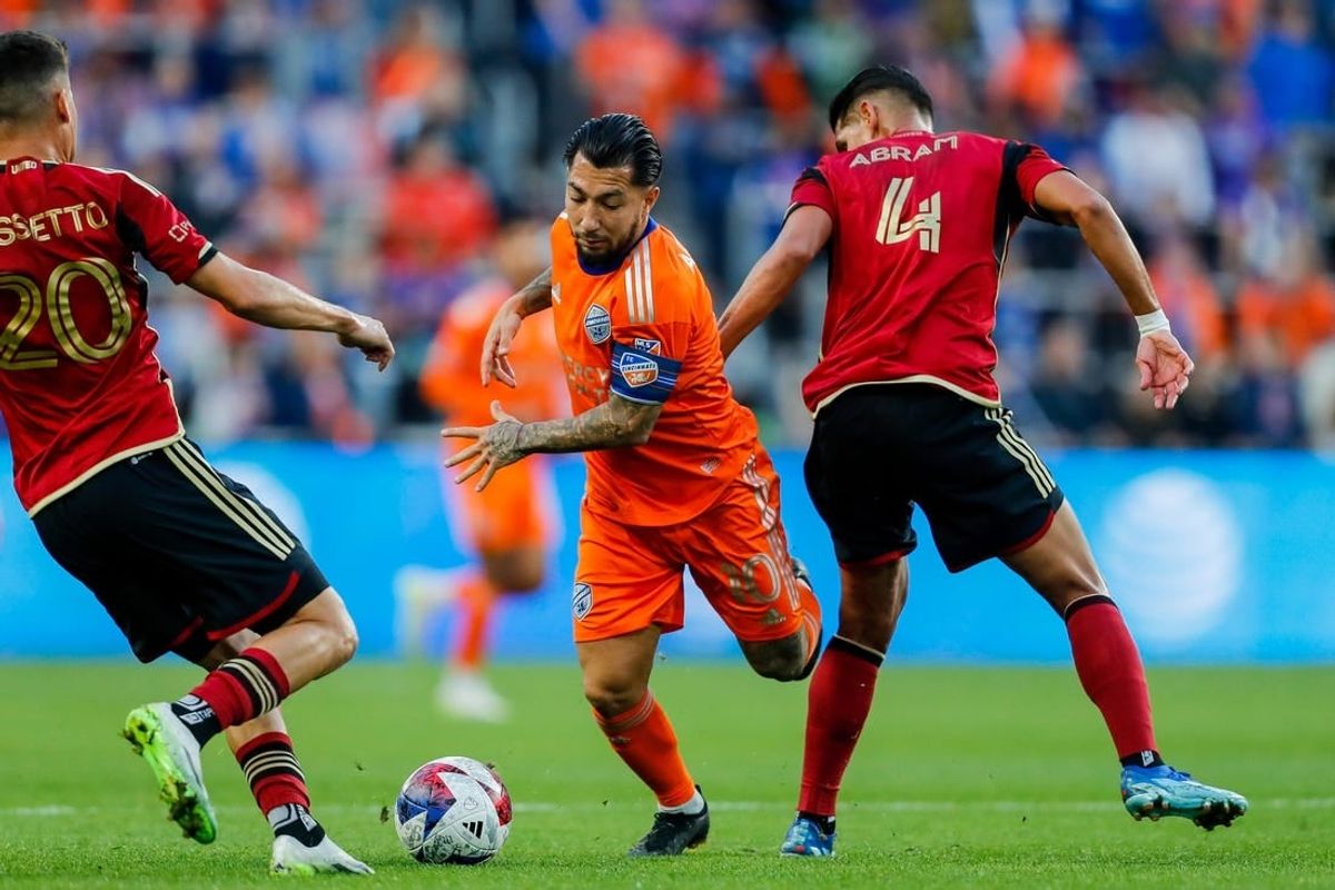 Oct 21, 2023; Cincinnati, Ohio, USA; FC Cincinnati midfielder Luciano Acosta (10) battles for the ball against Atlanta United FC midfielder Matheus Rossetto (20) and defender Luis Abram (4) in the first half at TQL Stadium.