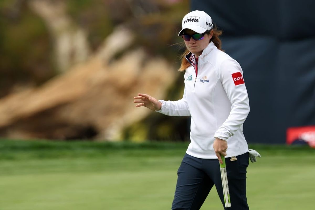 Jul 7, 2023; Pebble Beach, California, USA; Leona Maguire waves after making a birdie putt on the eighteenth green during the second round of the U.S. Women's Open golf tournament at Pebble Beach Golf Link.