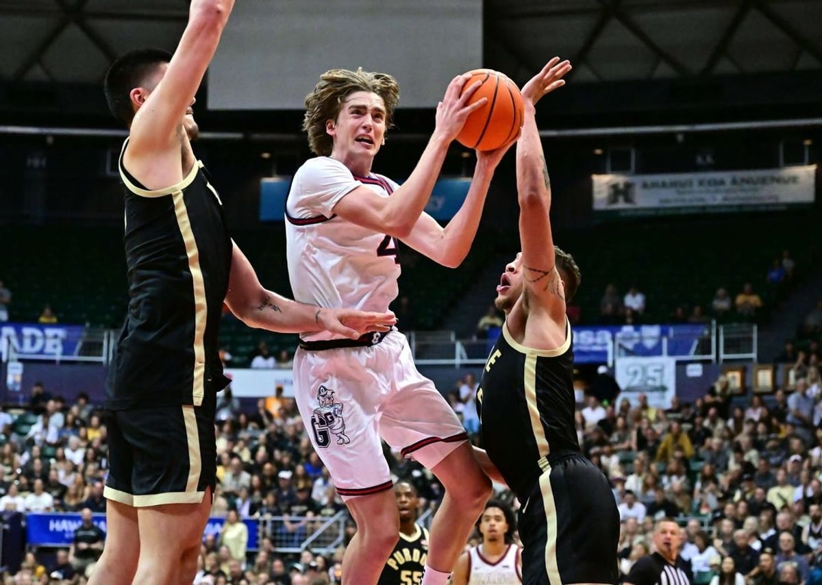 Nov 20, 2023; Honolulu, Hawaii, USA;  Gonzaga Bulldogs guard Dusty Stromer (4) drives to the basket defended by Purdue Boilermakers center Zach Edey (15) and forward Mason Gillis (0) during the second half at SimpliFi Arena at Stan Sheriff Center.