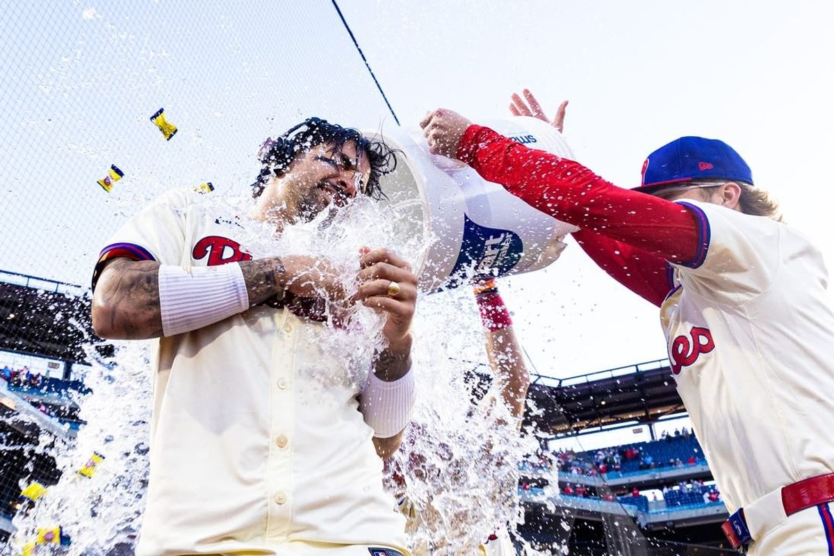 Apr 13, 2024; Philadelphia, Pennsylvania, USA; Philadelphia Phillies outfielder Nick Castellanos (8) is douse with water by second base Bryson Stott (5) after hitting a walk off RBI single during the ninth inning against the Pittsburgh Pirates at Citizens Bank Park.
