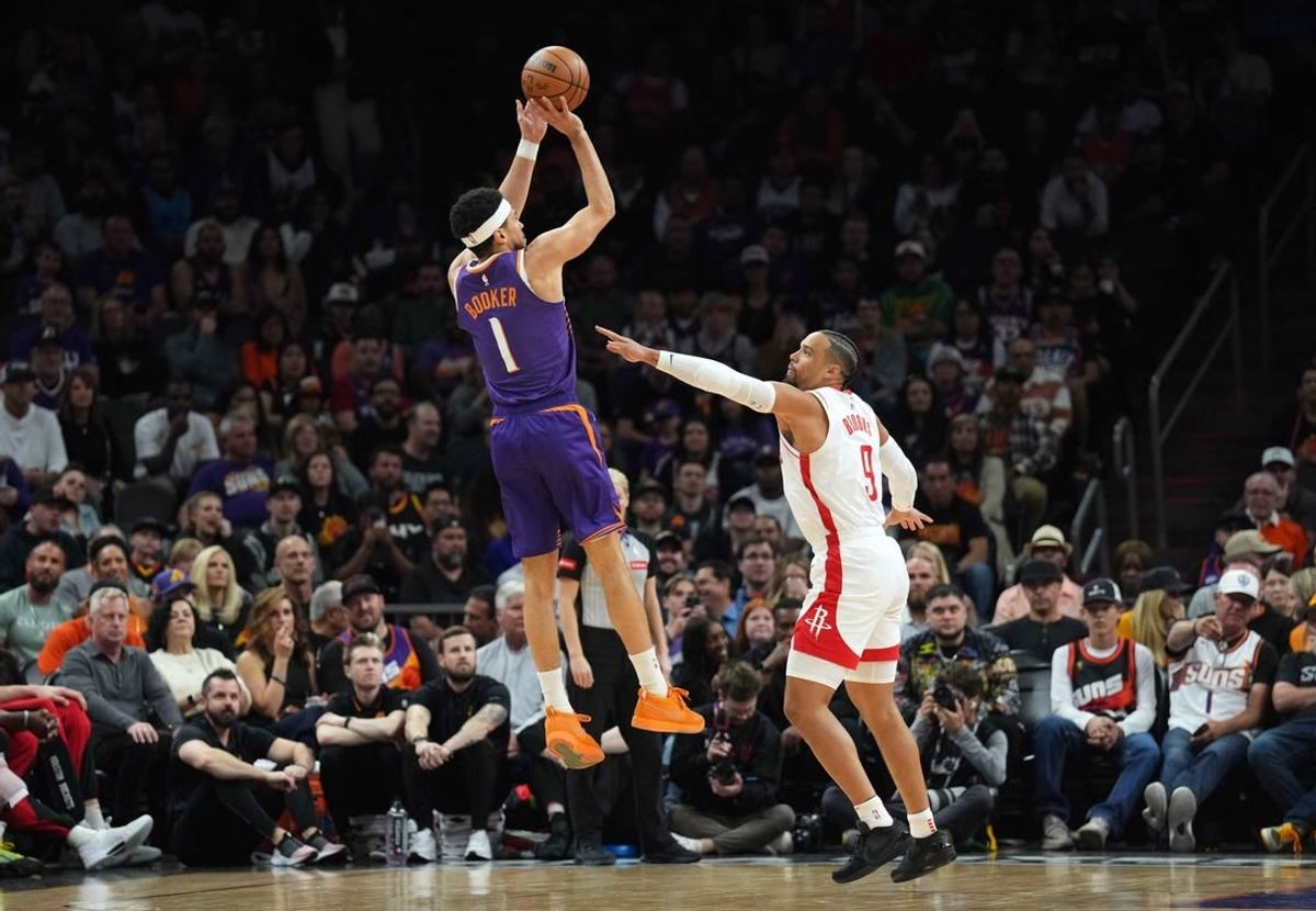 Mar 2, 2024; Phoenix, Arizona, USA; Phoenix Suns guard Devin Booker (1) shoots over Houston Rockets forward Dillon Brooks (9) during the first half at Footprint Center.