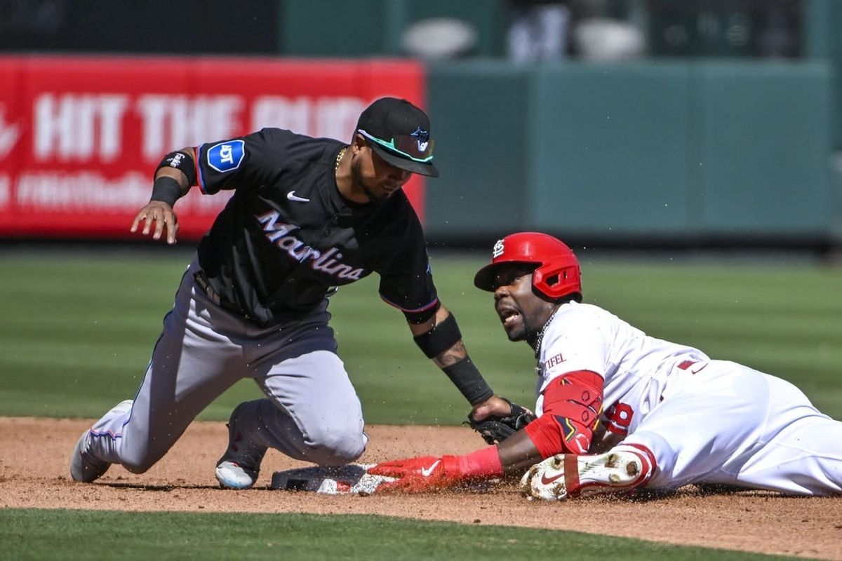 Apr 6, 2024; St. Louis, Missouri, USA;  St. Louis Cardinals right fielder Jordan Walker (18) reacts after sliding past the tag of Miami Marlins second baseman Luis Arraez (3) for a one run double during the fourth inning at Busch Stadium.