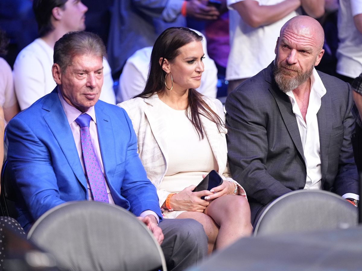 Vince and Stephanie McMahon with Triple H (r.)