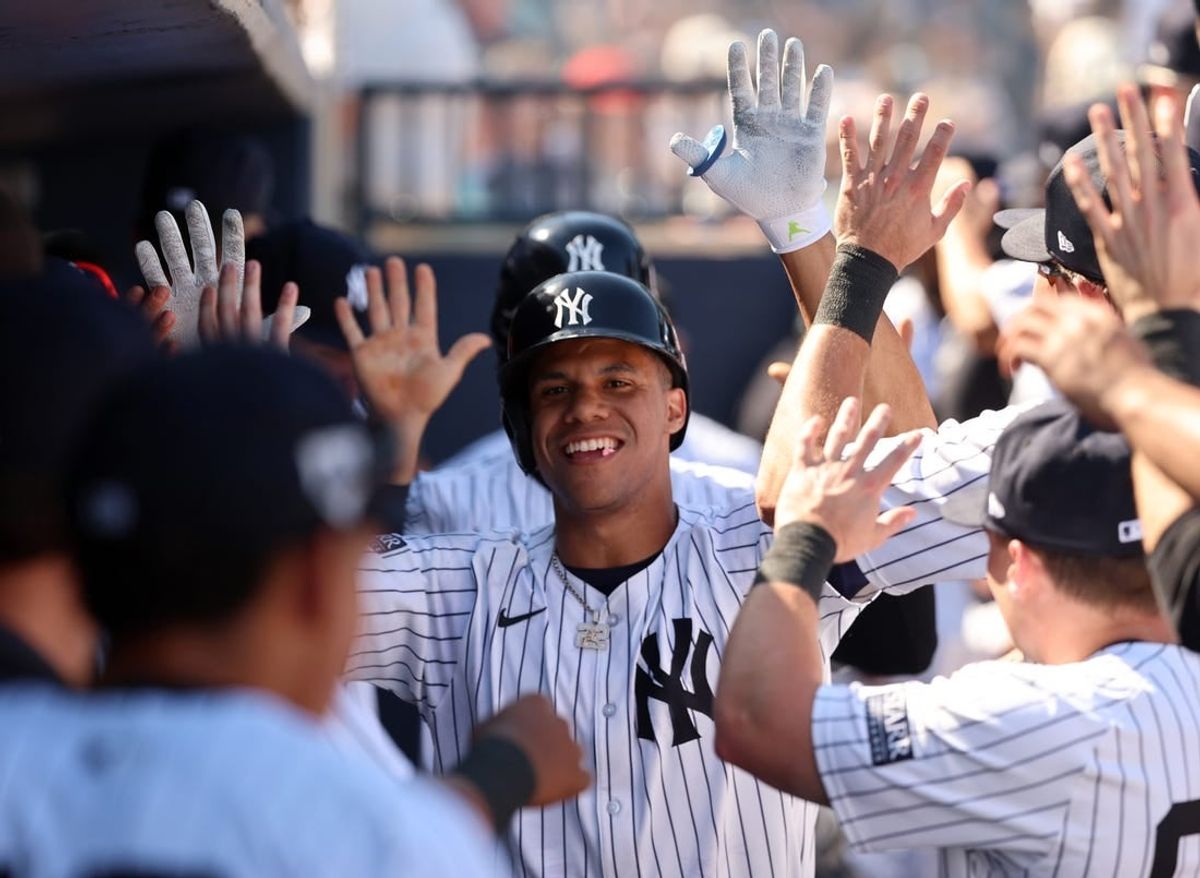 Feb 25, 2024; Tampa, Florida, USA; New York Yankees left fielder Juan Soto (22) celebrates in the dugout after he scores during the third inning against the Toronto Blue Jays at George M. Steinbrenner Field.
