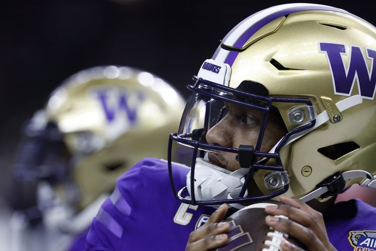 Jan 1, 2024; New Orleans, LA, USA; Washington Huskies quarterback Michael Penix Jr. (9) warms up during a timeout against the Texas Longhorns in the 2024 Sugar Bowl college football playoff semifinal game at Caesars Superdome.