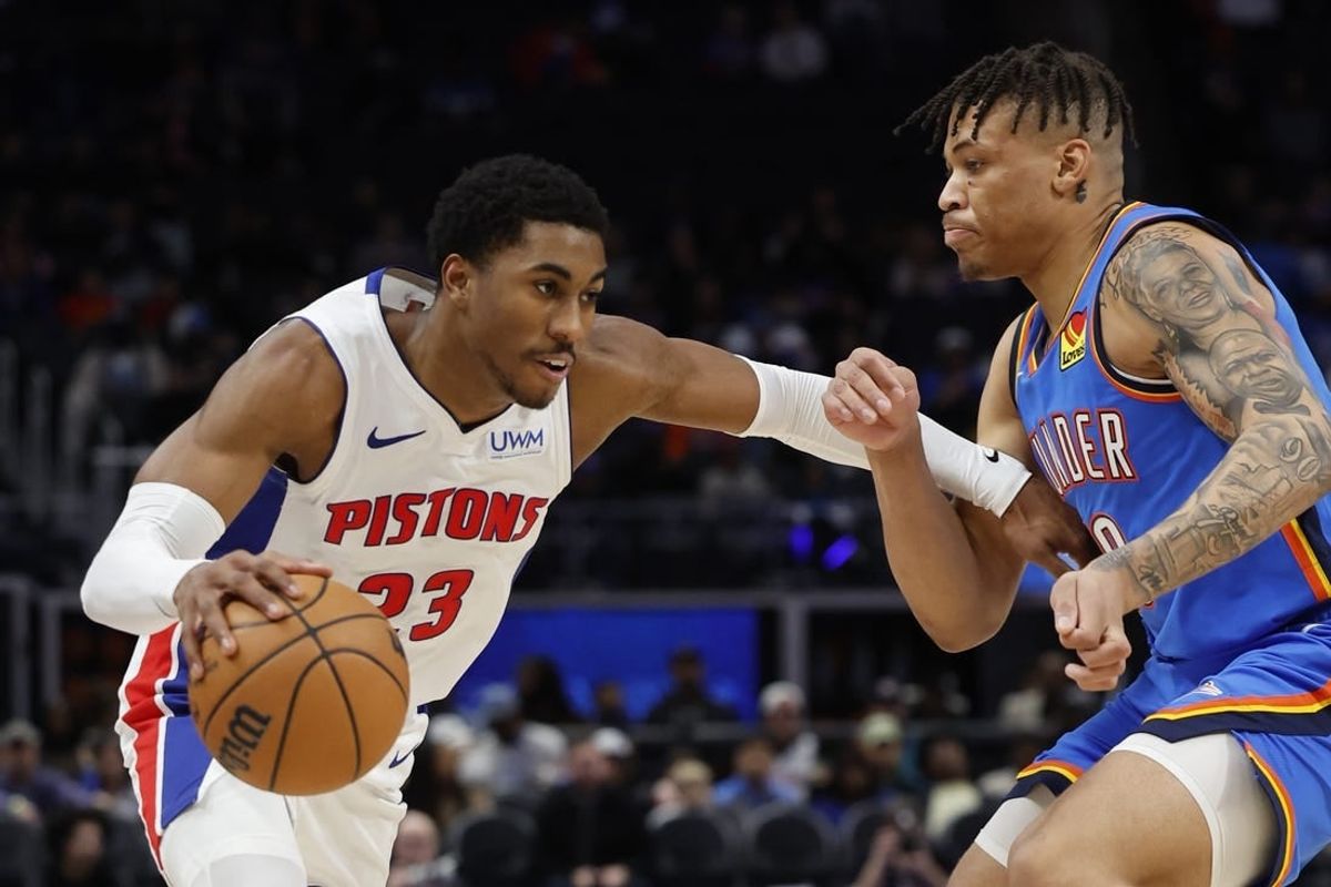 Jan 28, 2024; Detroit, Michigan, USA; Detroit Pistons guard Jaden Ivey (23) dribbles defended by Oklahoma City Thunder forward Keyontae Johnson (18) in the second half at Little Caesars Arena.