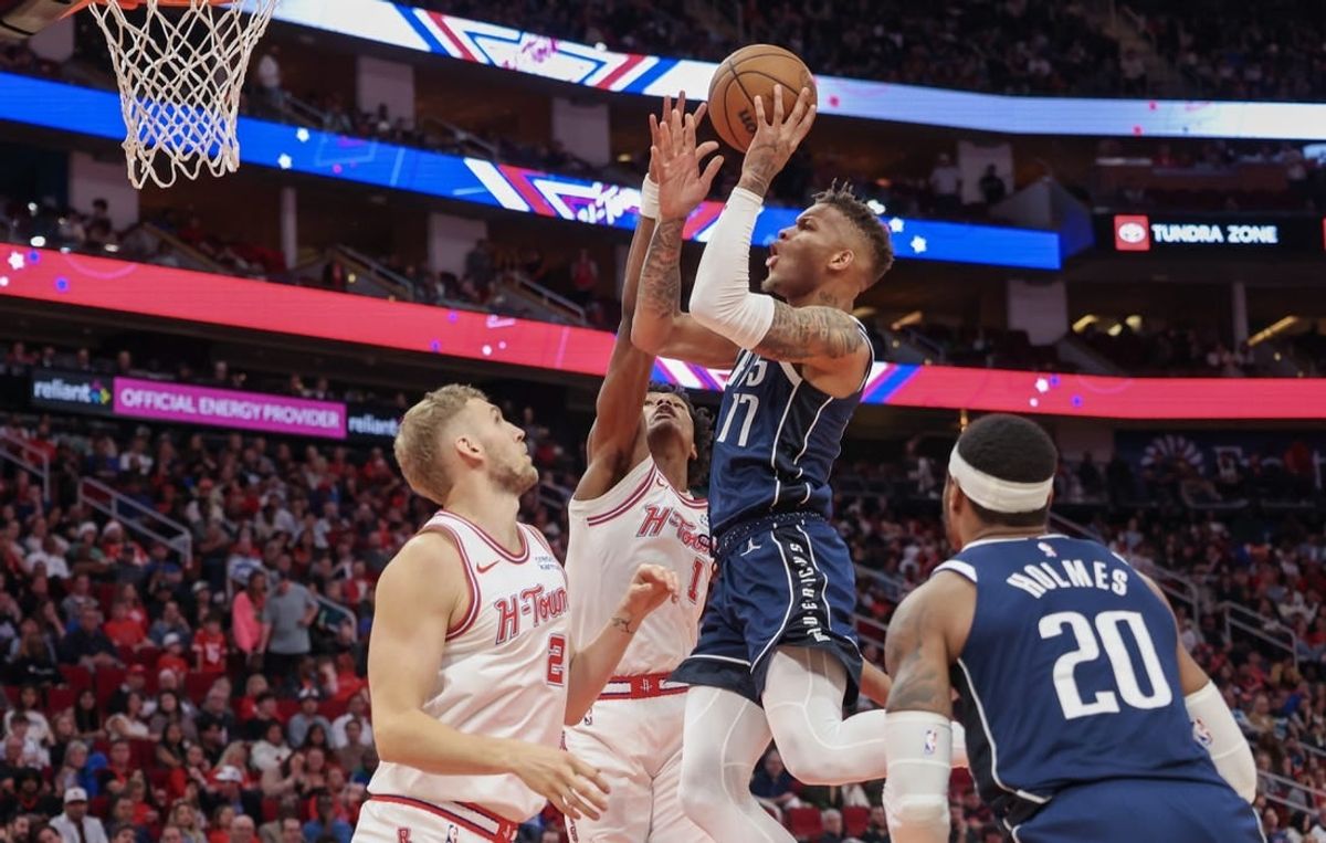 Dec 22, 2023; Houston, Texas, USA; Dallas Mavericks guard Dexter Dennis (17) shoots against Houston Rockets forward Amen Thompson (1) in the second half at Toyota Center.