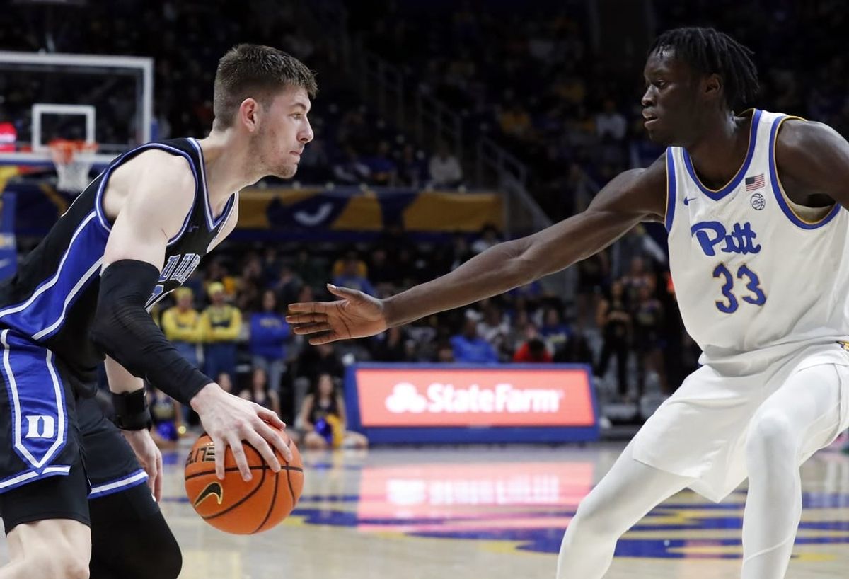 Jan 9, 2024; Pittsburgh, Pennsylvania, USA;  Duke Blue Devils center Kyle Filipowski (30) drives to the basket against Pittsburgh Panthers center Federiko Federiko (33) during the second half at the Petersen Events Center. Duke won 75-53.