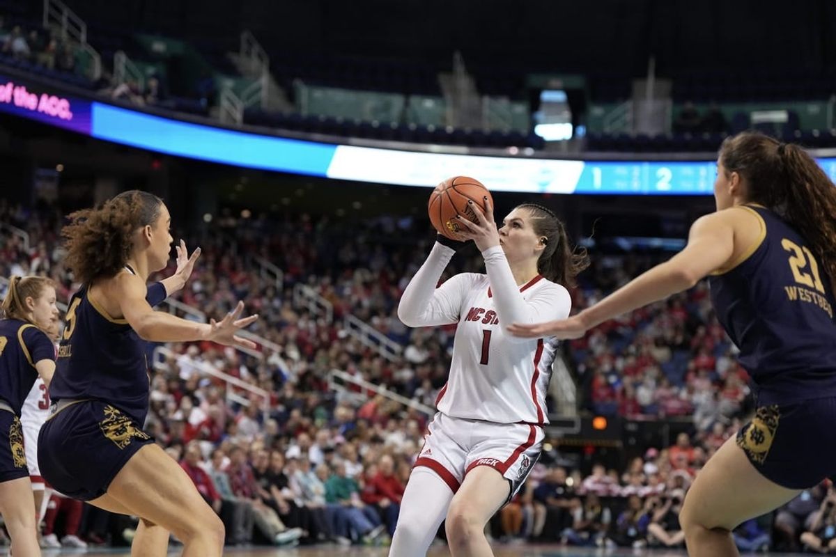 Mar 10, 2024; Greensboro, NC, USA; NC State Wolfpack center River Baldwin (1) shoots the ball over a defender in the first half against the Notre Dame Fighting Irish at Greensboro Coliseum.