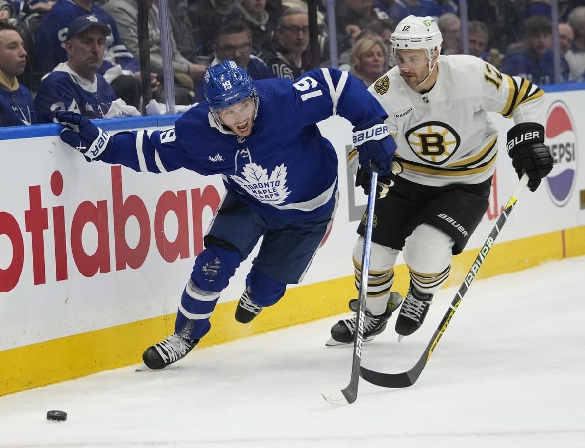 Apr 24, 2024; Toronto, Ontario, CAN; Toronto Maple Leafs forward Calle Jarnkrok (19) and Boston Bruins defenseman Kevin Shattenkirk (12) battle to get to the puck during the first period of game three of the first round of the 2024 Stanley Cup Playoffs at Scotiabank Arena.