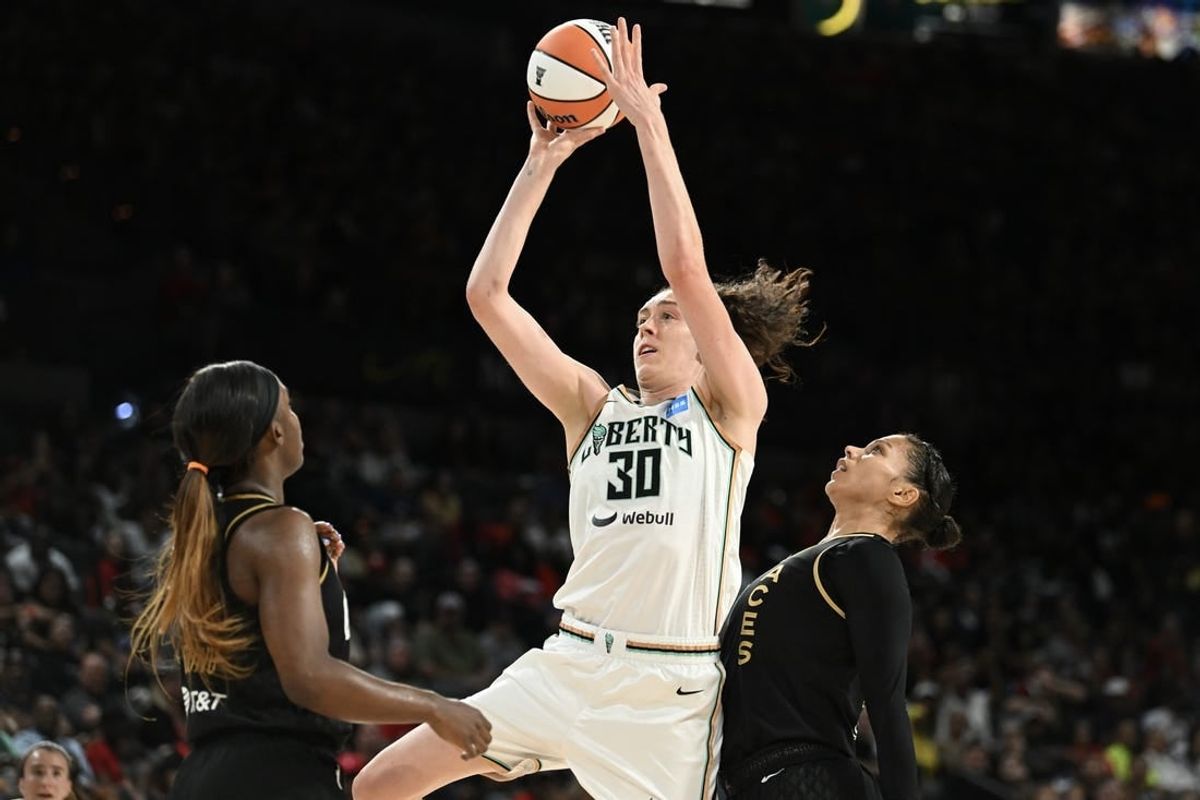 Aug 15, 2023; Las Vegas, Nevada, USA; New York Liberty forward Breanna Stewart (30) takes a shot against Las Vegas Aces guard Jackie Young (0) and forward Alysha Clark (7) during the second quarter at Michelob Ultra Arena.