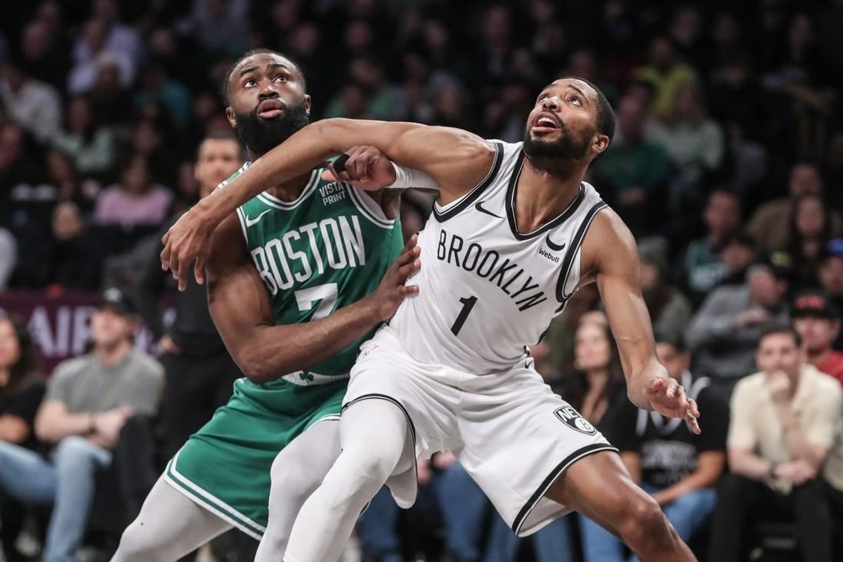 Feb 13, 2024; Brooklyn, New York, USA;  Boston Celtics guard Jaylen Brown (7) and Brooklyn Nets forward Mikal Bridges (1) box out for a rebound in the second quarter at Barclays Center.