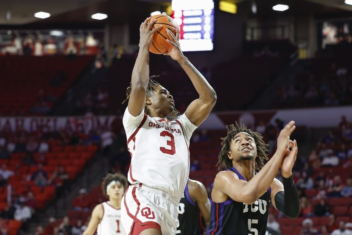 Mar 4, 2023; Norman, Oklahoma, USA; Oklahoma Sooners guard Otega Oweh (3) goes to the basket against TCU Horned Frogs forward Chuck O'Bannon Jr. (5) during the second half at Lloyd Noble Center. Oklahoma won 74-60.