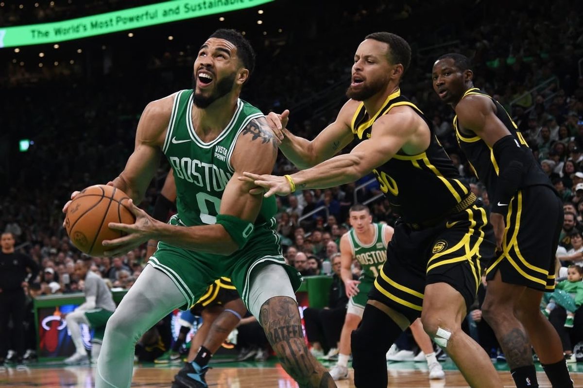 Mar 3, 2024; Boston, Massachusetts, USA;  Boston Celtics forward Jayson Tatum (0) controls the ball while Golden State Warriors guard Stephen Curry (30) defends during the first half at TD Garden.