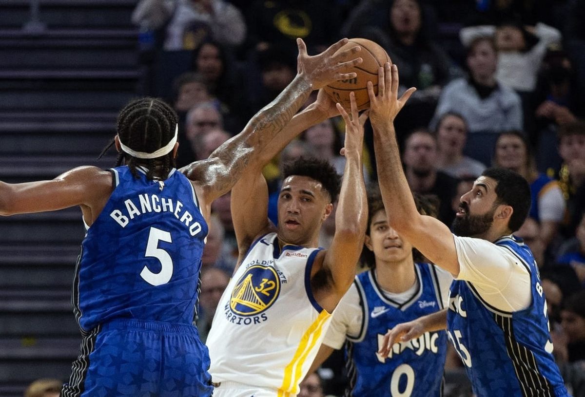 Jan 2, 2024; San Francisco, California, USA; Golden State Warriors forward Trayce Jackson-Davis (32) looks to pass away from defensive pressure from Orlando Magic players during the second quarter at Chase Center.