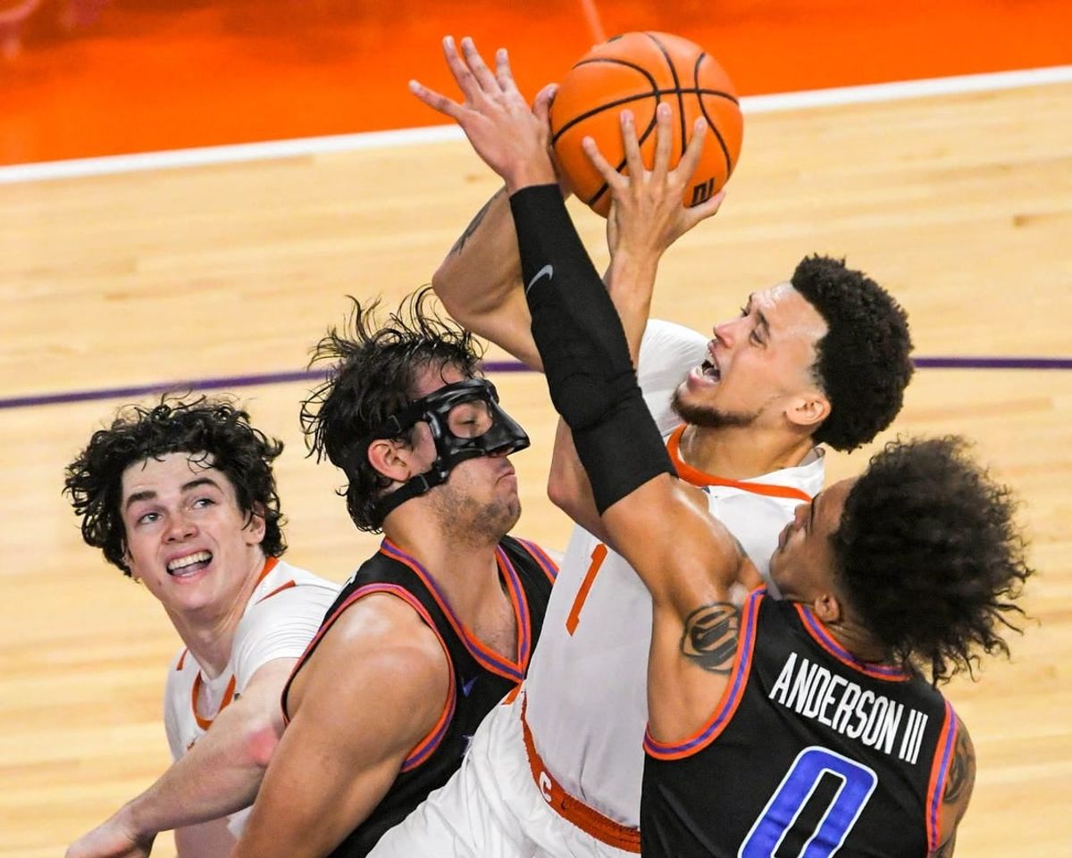 Sunday, November 19, 2023; Clemson senior guard Chase Hunter (1) scores near Boise State forward Tyson Degenhart (2) during the first half at Littlejohn Coliseum in Clemson, S.C. Sunday, November 19, 2023.