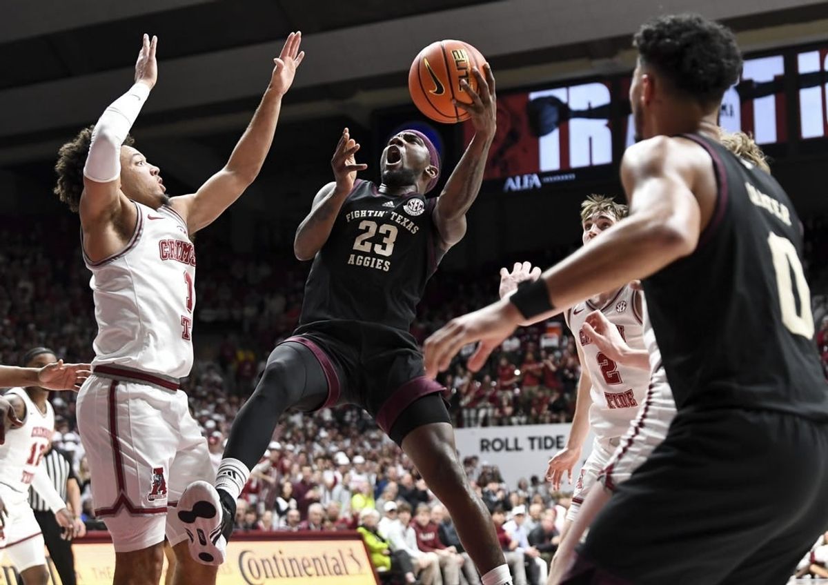 Feb 17, 2024; Tuscaloosa, Alabama, USA;  Texas A&M Aggies guard Tyrece Radford (23) shoots in the lane against Alabama Crimson Tide guard Mark Sears (1) during the first half at Coleman Coliseum.