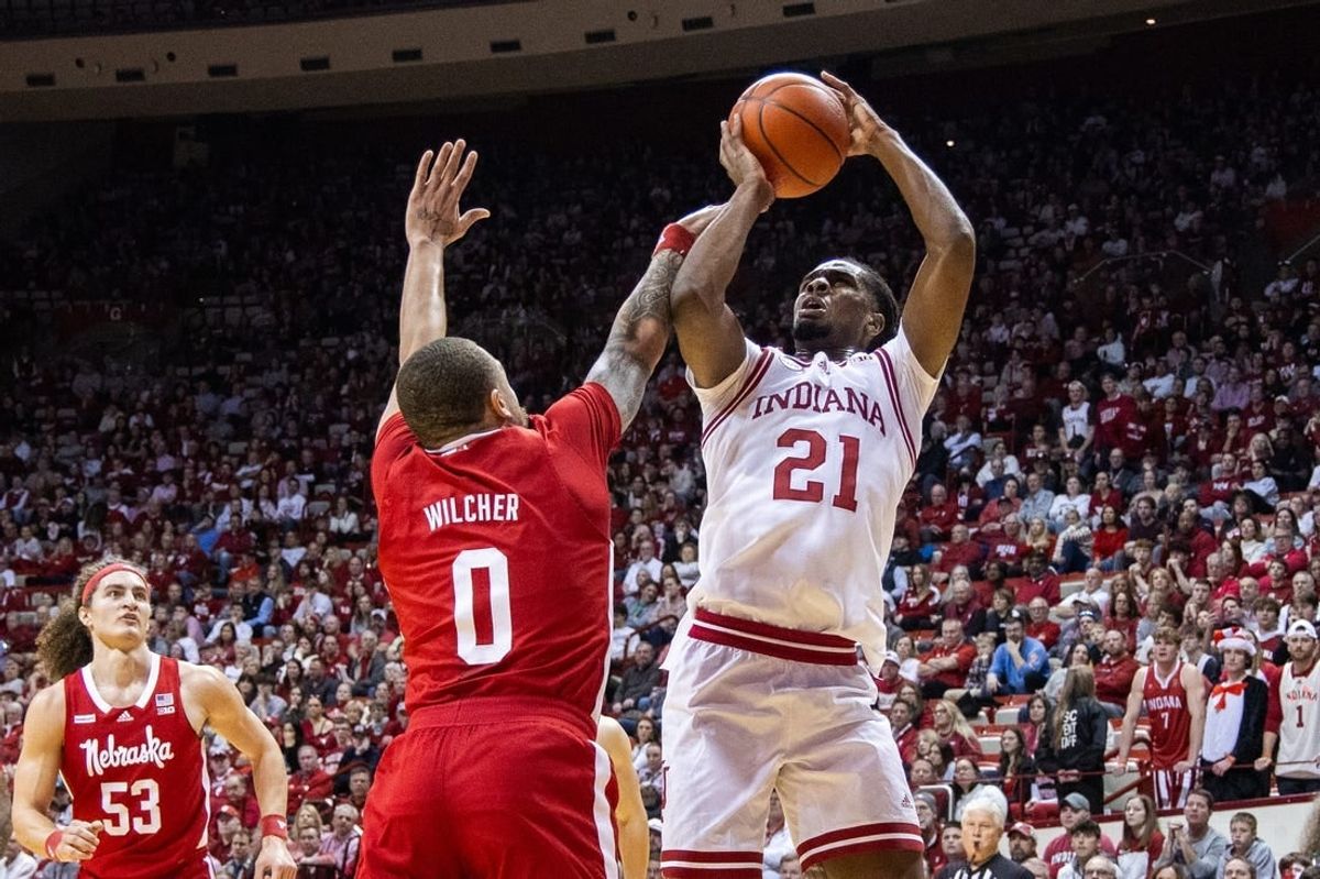 Feb 21, 2024; Bloomington, Indiana, USA; Indiana Hoosiers forward Mackenzie Mgbako (21) shoots the ball while Nebraska Cornhuskers guard C.J. Wilcher (0) defends in the first half at Simon Skjodt Assembly Hall.