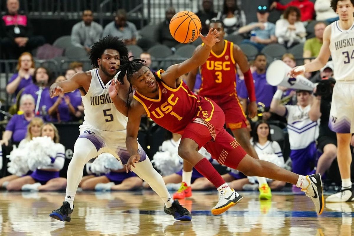 Mar 13, 2024; Las Vegas, NV, USA; USC Trojans guard Isaiah Collier (1) loses control of the ball near Washington Huskies guard Sahvir Wheeler (5) during the first half at T-Mobile Arena.
