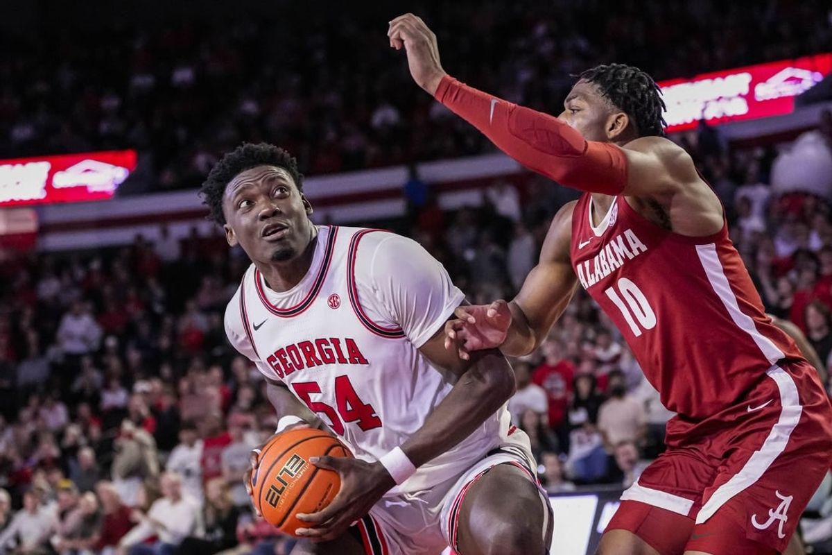 Jan 31, 2024; Athens, Georgia, USA; Georgia Bulldogs center Russel Tchewa (54) looks for a shot against Alabama Crimson Tide forward Mouhamed Dioubate (10) during the first half at Stegeman Coliseum.