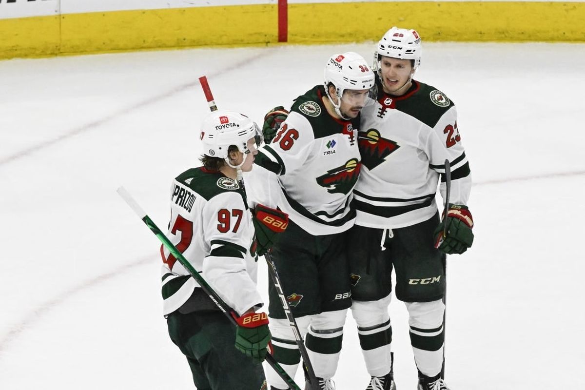 Apr 7, 2024; Chicago, Illinois, USA;  Minnesota Wild center Marco Rossi (23) celebrates his goal against the Chicago Blackhawks with  right wing Mats Zuccarello (36) and left wing Kirill Kaprizov (97)  during the second period at United Center.