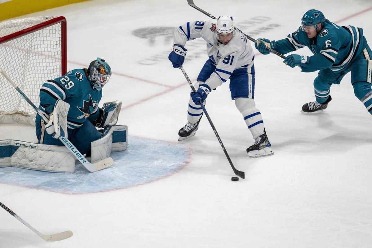 Jan 6, 2024; San Jose, California, USA; Toronto Maple Leafs center John Tavares (91) passes the puck to Toronto Maple Leafs right wing William Nylander (not pictured) in front of San Jose Sharks goaltender Mackenzie Blackwood (29) during the third period at SAP Center at San Jose.