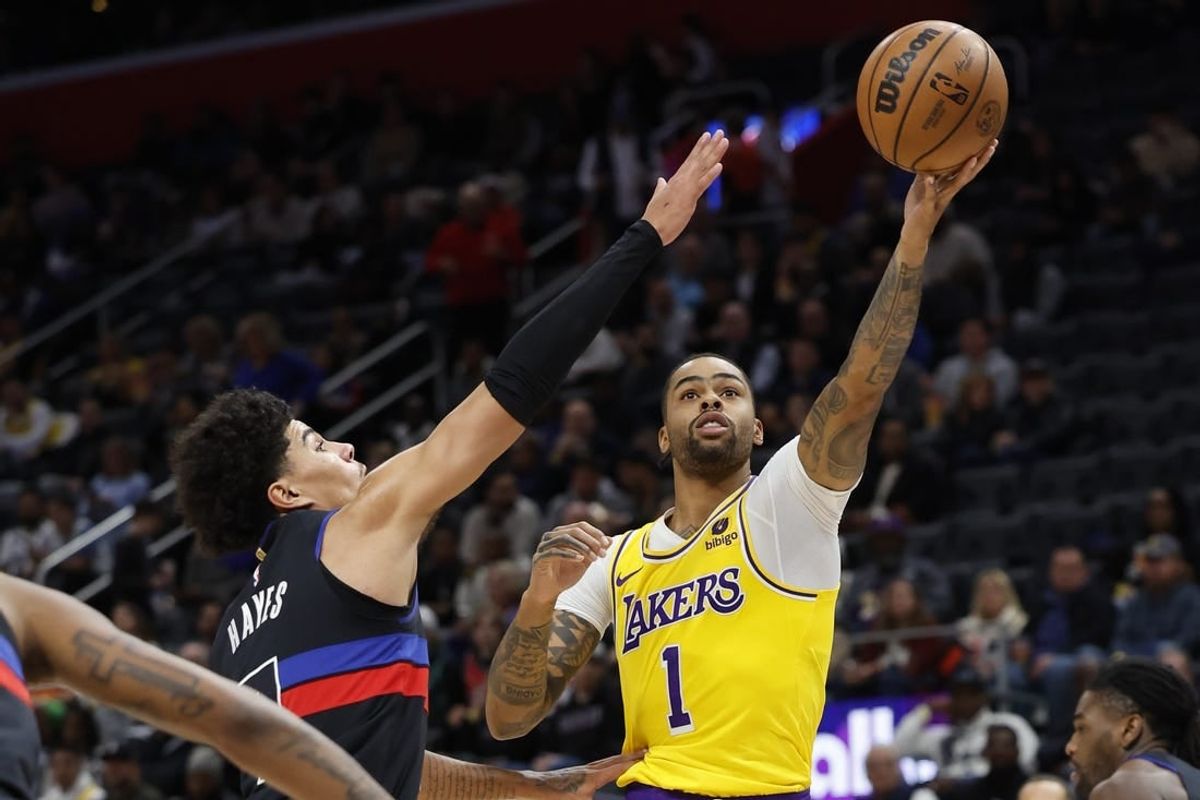 Nov 29, 2023; Detroit, Michigan, USA; Los Angeles Lakers guard D'Angelo Russell (1) shoots on Detroit Pistons guard Killian Hayes (7) in the first half at Little Caesars Arena.