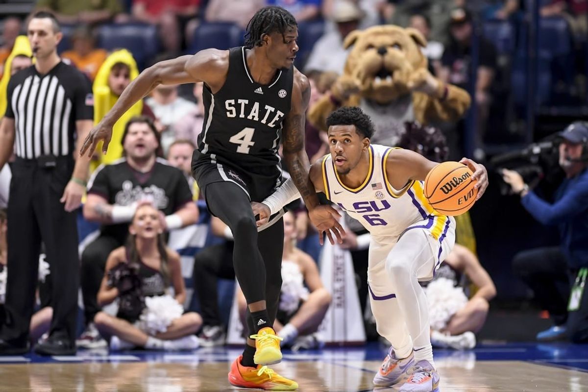 Mar 14, 2024; Nashville, TN, USA; LSU Tigers guard Jordan Wright (6) dribbles as Mississippi State Bulldogs forward Cameron Matthews (4) guards during the first half at Bridgestone Arena.