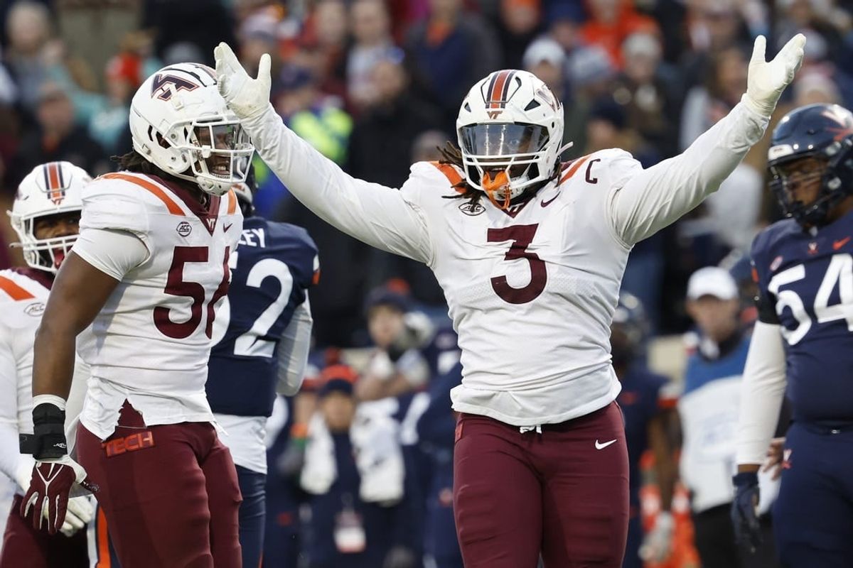 Nov 25, 2023; Charlottesville, Virginia, USA; Virginia Tech Hokies defensive lineman Norell Pollard (3) celebrates after recording a sack against the Virginia Cavaliers during the second quarter at Scott Stadium.