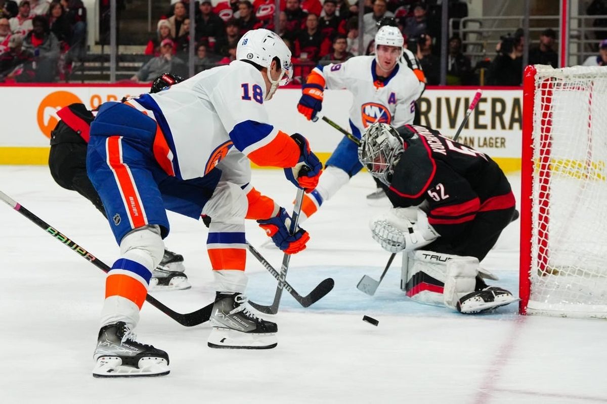 Nov 30, 2023; Raleigh, North Carolina, USA; Carolina Hurricanes goaltender Pyotr Kochetkov (52) stops the scoring attempt by New York Islanders left wing Pierre Engvall (18) during the second period at PNC Arena.