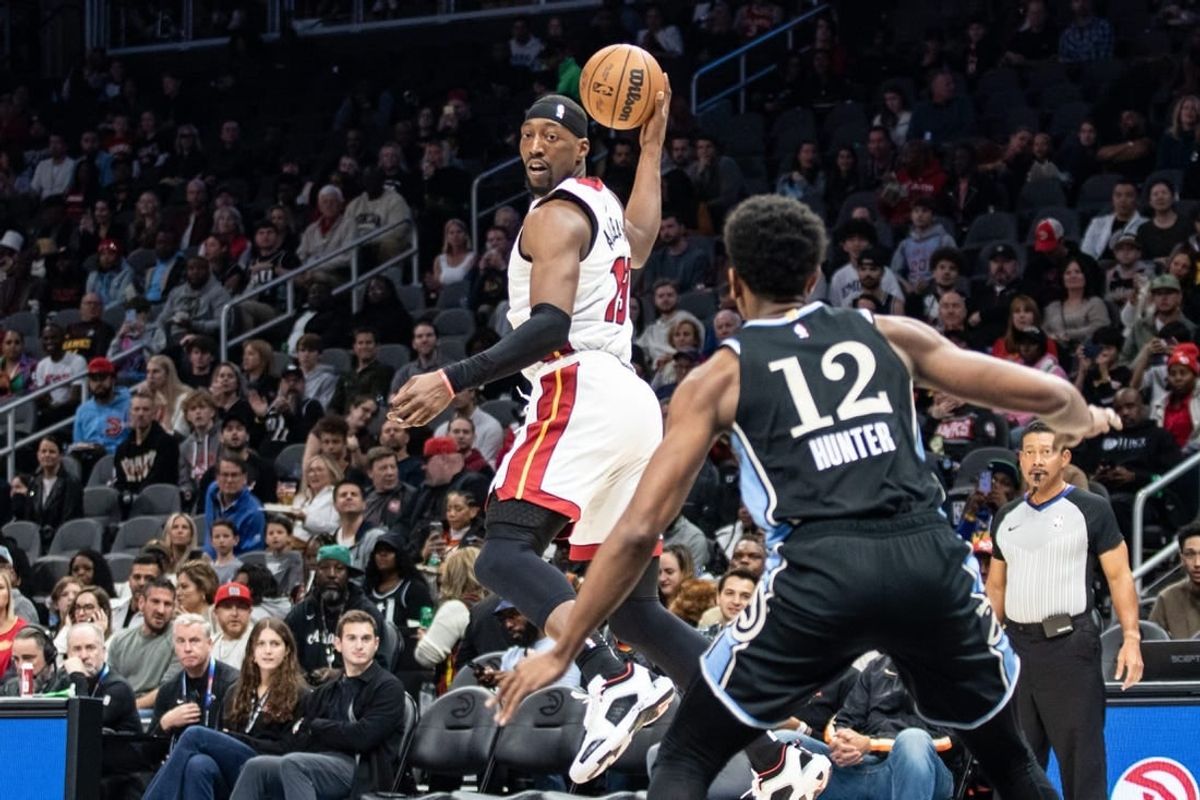 Nov 11, 2023; Atlanta, Georgia, USA; Miami Heat center Bam Adebayo (13) saves the ball from going out of bounds against Atlanta Hawks forward De'Andre Hunter (12) during the first quarter at State Farm Arena.
