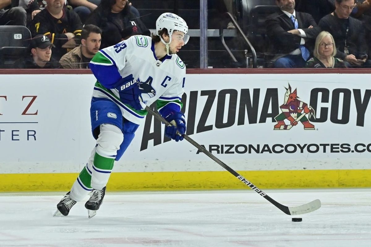 Apr 3, 2024; Tempe, Arizona, USA; Vancouver Canucks defenseman Quinn Hughes (43) carries the puck in the second period against the Arizona Coyotes at Mullett Arena.