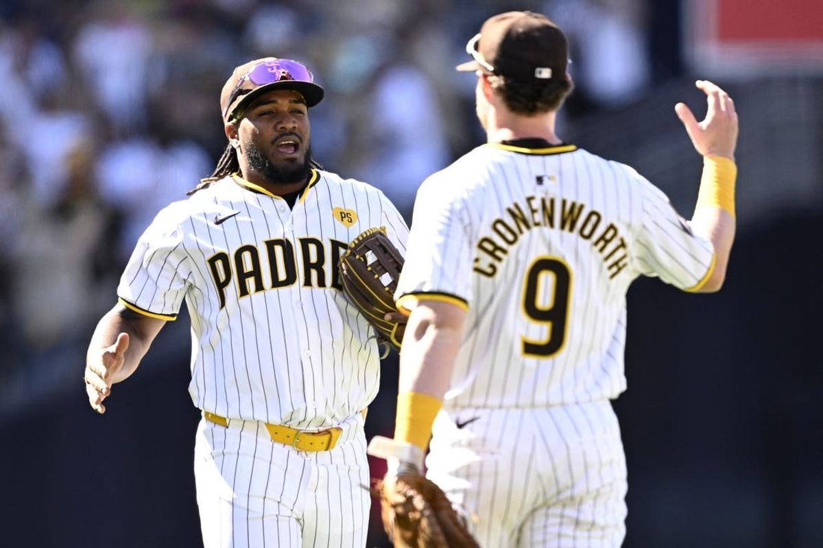 Mar 28, 2024; San Diego, California, USA; San Diego Padres third baseman Eguy Rosario (5) and first baseman Jake Cronenworth (9) celebrate on the field after defeating the San Francisco Giants at Petco Park.