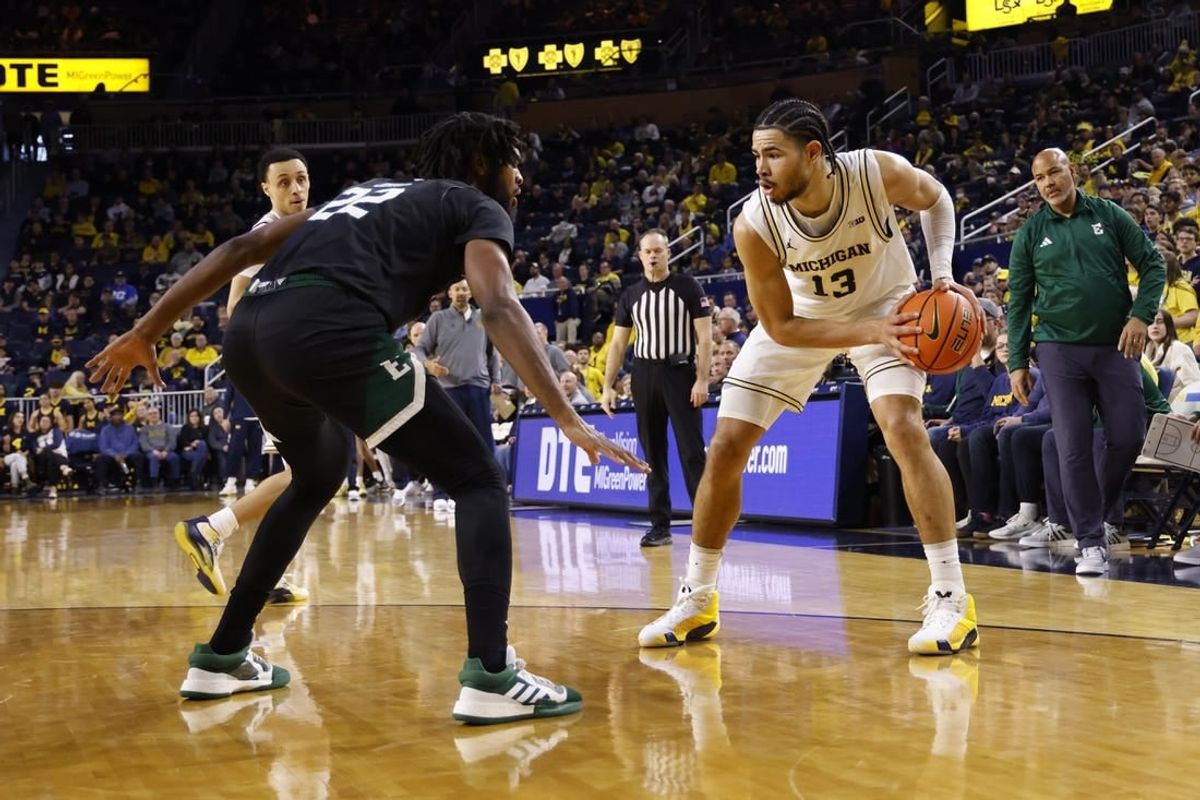 Dec 16, 2023; Ann Arbor, Michigan, USA; Michigan Wolverines forward Olivier Nkamhoua (13) is defended by Eastern Michigan Eagles forward Yusuf Jihad (22) in the first half at Crisler Center.