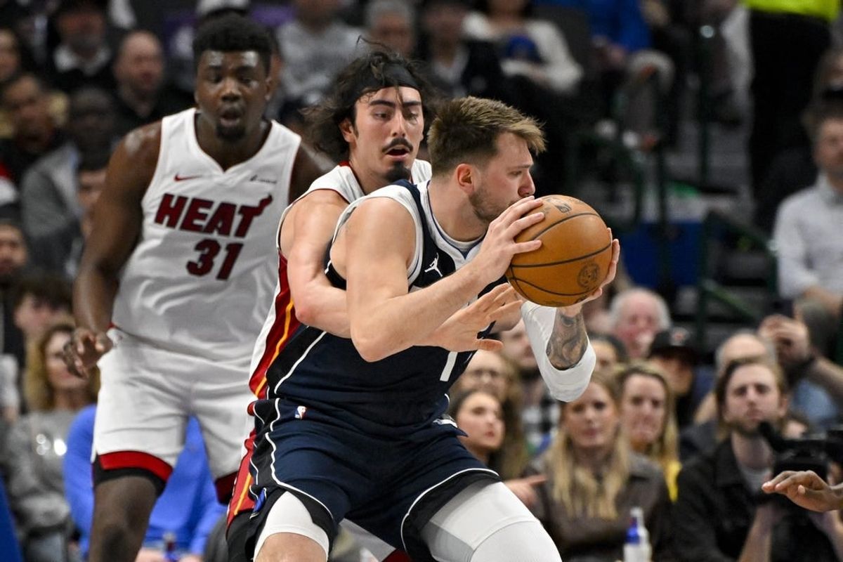 Mar 7, 2024; Dallas, Texas, USA; Miami Heat guard Jaime Jaquez Jr. (11) attempts to knock the ball away from Dallas Mavericks guard Luka Doncic (77) during the first half at the American Airlines Center.